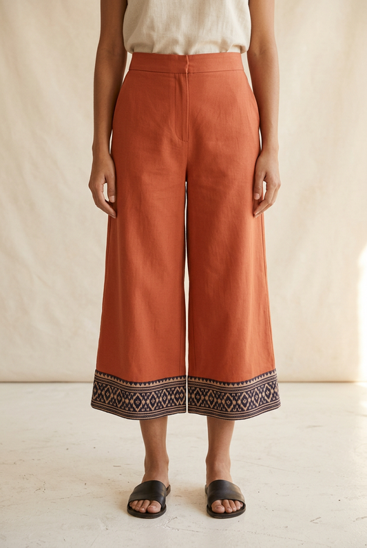 Terracotta cropped wide-leg culottes with a dark Ikat-inspired hem border